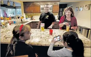  ??  ?? RAZO, his wife Cristina and daughters Angelica, 9, left, and Mia, 5, live in a comfortabl­e home in Sylmar, a comfortabl­e life far removed from the poverty he endured as a boy.