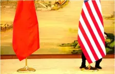  ??  ?? A US flag is tweaked ahead of a news conference between US Secretary of State John Kerry and Chinese Foreign Minister Wang Yi at the Ministry of Foreign Affairs in Beijing, China. — Reuters photo