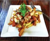  ??  ?? Downie Street Burgers’ maple bacon poutine was specially created for the Savour Stratford Maple Trail. However, owner Joe Gilchrist is considerin­g adding it to his regular menu, since it is proving popular.