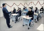  ?? KHALID MOHAMMED — THE ASSOCIATED PRESS ?? Chinese lecturer Zhiwei Hu speaks to students in the Chinese language department at Salahaddin University in Irbil, Iraq. The school is attracting students who hope to land jobs with a growing number of Chinese companies in the region.