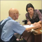  ??  ?? Dr. Gretchen Magee presents Joe with his hearing aids.