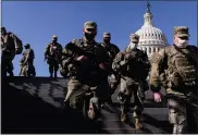  ?? ANDREW HARNIK - THE ASSOCIATED PRESS ?? Members of the National Guard walk past the Dome of the Capitol Building on Capitol Hill in Washington, Thursday, Jan. 14, 2021.