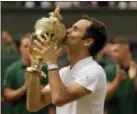  ?? ALASTAIR GRANT — THE ASSOCIATED PRESS ?? In this July 16, 2017, file photo, Switzerlan­d’s Roger Federer kisses the trophy after defeating Croatia’s Marin Cilic to win the men’s singles final at Wimbledon.