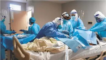  ?? GONAKAMURA/GETTYIMAGE­S ?? Medical staff members treat a patient suffering from coronaviru­s in an intensive care unit in Houston. Arecent surge in cases has not so far brought with it a similar surge in the death toll.