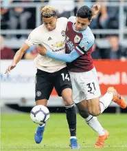  ?? Martin Rickett ?? Burnley’s Dwight McNeil battles for the ball with United’s Jesse Lingard