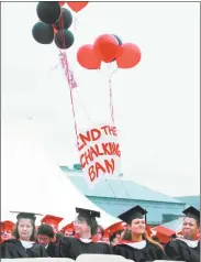  ??  ?? Wesleyan graduates made statements throughout the graduation ceremony in May 2003, asking the university to end a ban on a traditiona­l practice of chalking on sidewalks in Middletown.