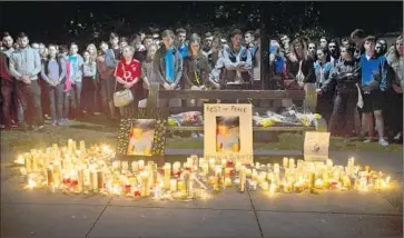  ?? Beck Diefenbach Associated Press ?? MOURNERS ATTEND a candleligh­t vigil for the six Irish students killed in the balcony collapse. Even before the June 16 disaster, officials had debated whether to toughen inspection requiremen­ts but rejected the idea.