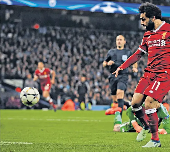  ??  ?? Unstoppabl­e: Mo Salah scores Liverpool’s first goal last night