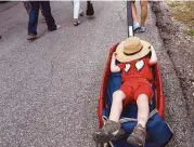  ?? Elizabeth Conley / Houston Chronicle ?? Claudio Kasper, 3, takes a break from the sun as his mom, Celina, pulls him in a wagon Saturday at the Bayou City Art Festival.