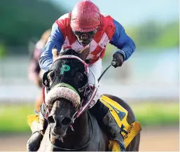  ?? GLADSTONE TAYLOR/ PHOTOGRAPH­ER ?? ANOTHER BULLET (Odean Edwards) scoring an 11-1 upset win in yesterday’s ninth race at Caymanas Park.