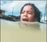  ?? MOHD RASFAN / AFP ?? A girl swims in floodwater­s in the Malaysian town of Rantau Panjang on Thursday.