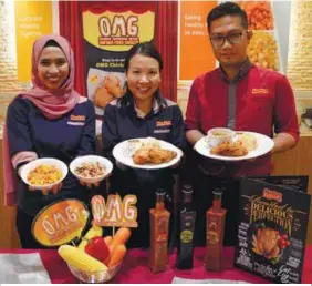  ??  ?? Thong (centre) and KRR staff with the new menu options; (top, from left) the OMG Chicken Meal; the new triple bean salad and smokey corn bites; and the OMG Chicken + Soup Meal.
