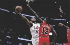  ?? AP PHOTO/RON SCHWANE ?? Cleveland Cavaliers guard Donovan Mitchell (45) shoots against Chicago Bulls guard Ayo Dosunmu (12) during the second half of an NBA basketball game, on Saturday in Cleveland.