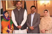  ?? AP/Press Informatio­n Department ?? Malala Yousafzai (from left) poses with Pakistani Prime Minister Shahid Khaqan Abbasi and her parents Thursday in Islamabad on her return to Pakistan.