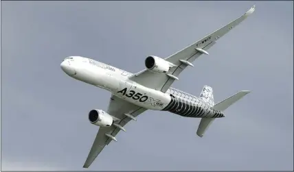  ?? AP PHOTO ?? An Airbus A350  ies during the ILA Berlin Air Show in Berlin. Aviation giant Airbus has threatened to leave Britain if the country leaves the European Union without an agreement on future trading relations.