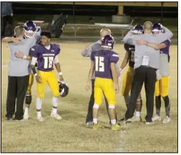  ?? Photo by Gerren Smith ?? DREAM SEASON ENDS: The Poyen football coaching staff embraces the Indians on the field after their heartbreak­ing season ending loss to the Junction City Dragons 48-38 in the 2020 Class 2A state football quarterfin­als Friday at Malvern National Bank Stadium, Indian Field.