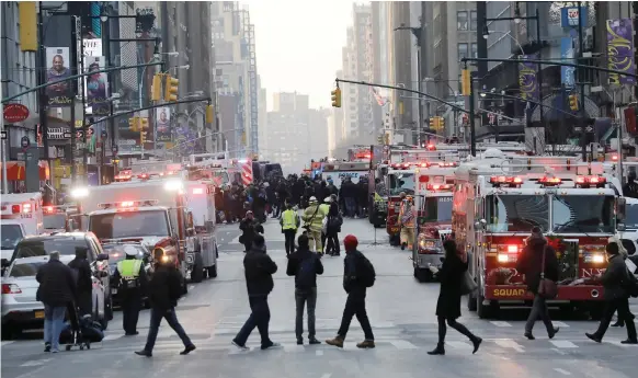  ?? EPA ?? Emergency vehicles outside the New York Port Authority. The city was already on high alert after eight people were killed by an ISIL-inspired attacker in October