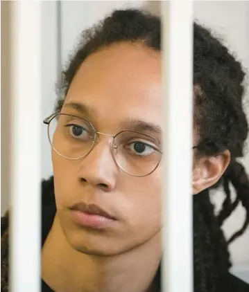  ?? ALEXANDER ZEMLIANICH­ENKO/AP ?? WNBA star and two-time Olympic gold medalist Brittney Griner sits in a cage at a court room prior to a hearing on July 27 in Khimki, just outside Moscow, Russia.