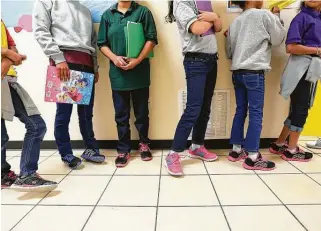  ?? Eric Gay / Associated Press file photo ?? Migrant teens line up for a class at a “tender-age” facility in San Benito in 2019. The Biden administra­tion is working to speed up the release of children to their relatives.