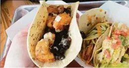  ?? Leeanne Griffin / Hearst Connecticu­t Media ?? A spicy adobo-marinated shrimp taco with black beans, corn and crema verde, and a Newport chicken taco with guacamole, bacon and chipotle mayo.