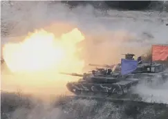  ??  ?? 0 South Korean and US tanks fire live rounds during a joint drill