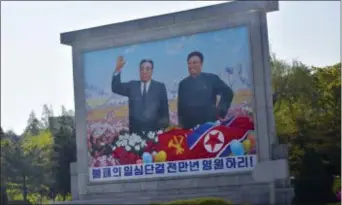  ?? MATTHEW LEE, POOL - THE ASSOCIATED PRESS ?? Portraits of late leaders Kim Il Sung, left, and Kim Jong Il, left, are seen along the motorcade route transporti­ng Secretary of State Mike Pompeo and US diplomats in Pyonyang, North Korea, Wednesday, May 9, 2018.