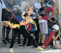  ?? Picture: AFP ?? FIGHTING FIRE WITH FIRE: Opposition activists clash with the police during a demonstrat­ion marking 100 days of protests against Venezuelan President Nicolas Maduro in Caracas