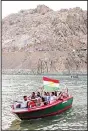  ??  ?? Iraqi Kurds ride in a boat flying the Kurdish flag during the Watercraft festival on Aug 25, in lake Darband in Raniya district, 70 km (43 miles) east of Arbil, the capital of the autonomous
region of Kurdistan. (AFP)