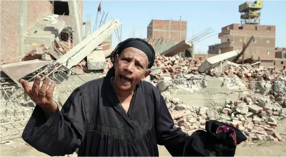  ?? EPA ?? An Egyptian woman reacts in front of a destroyed house in Al Warraq Island in Giza last week