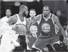  ?? ASSOCIATED PRESS FILE PHOTO ?? Cleveland forward LeBron James, left, leads the Cavaliers against Kevin Durant and the Golden State Warriors today in Oakland, Calif.