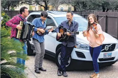  ?? AMY CASTNER / FOR STATESMAN CONTENT MARKETING ?? Lost & Nameless puts on a little show in front of Tammy Zielnicki’s 2012 Volvo XC60. The band members are, from left, Nathan Quiring, Chris Peterson, Patrick Conway and Kimberly Zielnicki.