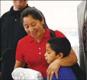  ?? AP PHOTO ?? Beata Mariana de Jesus Mejia-mejia embraces her son Darwin Micheal Mejia as she speaks at a news conference following their reunion at Baltimore-washington Internatio­nal Thurgood Marshall Airport on Friday.