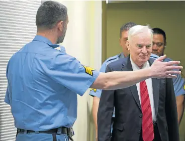  ?? /AFP Photo ?? War criminal: Bosnian Serb military chief Ratko Mladic, right, enters the Internatio­nal Criminal Tribunal for the former Yugoslavia on Wednesday to hear the verdict in his trial. The judge described his crimes as “amongst the most heinous known to...