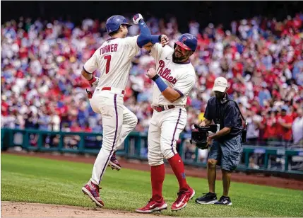  ?? AP 2023 ?? Some Philadelph­ia fans didn’t think he deserved it, but the Phillies’ Trea Turner (left), here with Kyle Schwarber after Turner’s two-run homer against Miami on Sept. 10, made the most of the city’s notorious fandom deciding to praise him rather than slam him during a slump.