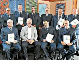  ??  ?? Northland Regional Correction­s facility staff receive long-service awards from Correction­s Minister Kelvin Davis.