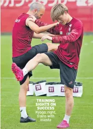  ?? ?? TRAINING SIGHTS ON SUCCESS Kyogo, right, trains with Iniesta