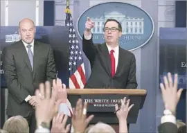  ?? Michael Reynolds European Pressphoto Agency ?? TREASURY Secretary Steven Mnuchin, right, said the tax plan “will pay for itself with growth and with reduction of different deductions and closing loopholes.”