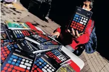  ?? AFP ?? A STREET vendor holds a copy of the draft of Chile’s new constituti­on in downtown Santiago, on July 26, 2022. Chile votes on September 4 in a referendum to approve or reject the draft of the new constituti­on. |