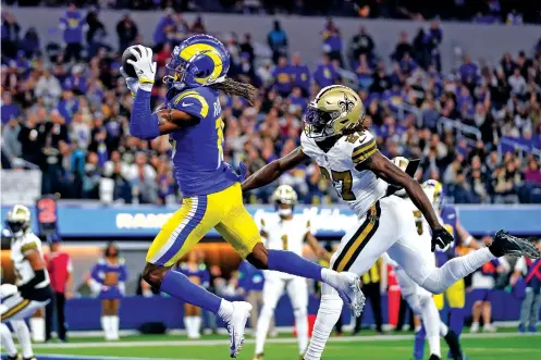  ?? ASHLEY LANDIS/THE ASSOCIATED PRESS ?? Los Angeles Rams wide receiver Demarcus Robinson makes a touchdown catch past New Orleans Saints cornerback Isaac Yiadom during the first half of Thursday’s game in Inglewood, Calif. The Rams won 30-22 to surge ahead in the NFC playoff race.