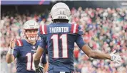  ?? Nancy Lane/TNS ?? New England Patriots wide receiver Tyquan Thornton celebrates his touchdown with quarterbac­k Mac Jones during the first quarter against the Miami Dolphins at Gillette Stadium on Jan. 1 in Foxboro, Mass.