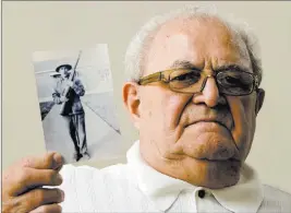  ?? Matt Rourke ?? The Associated Press Dominic Ragucci holds up a photo of his brother, Emil, who was killed in action during World War II. His remains were returned to the family Monday.