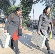  ??  ?? Officials on their way to polling stations in Jalandhar on Saturday. Over 1,700 cops will be deployed in the city. PARDEEP PANDIT/HT