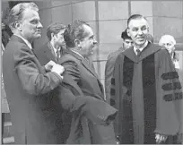  ?? Associated Press ?? ‘I SOMETIMES CROSSED THE LINE’ Graham helps Richard Nixon with his coat in 1969. The minister’s relationsh­ip with Nixon was not without controvers­y.