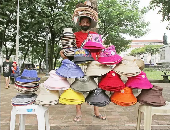  ?? PHOTOGRAPH BY JOEY SANCHEZ MENDOZA FOR THE DAILY TRIBUNE@tribunephl_joey ?? HATS of various colors and designs are sold outside the Manila Cathedral Church in Intramuros, Manila on Thursday.