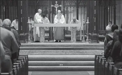  ??  ?? Eight priests wearing white vestments administer­ed at a recent Mass of Healing. Some who attend the special services are medical profession­als and caregivers in search of guidance and support.