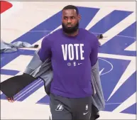  ?? Sam Greenwood / Getty Images ?? The Lakers’ LeBron James wears a “Vote” shirt during warmups before Game 5 of the NBA Finals against the Heat on Oct. 9.