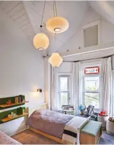  ??  ??  The original cathedral ceiling and stained glass windows are the main attraction­s in this kids’ bedroom. Bedside shelves by Alki; Nelson pendants from Lightform.