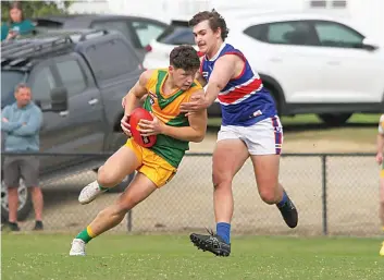  ?? ?? Garfield’s Jesse Wouters looks to break through the tackle of Bunyip’s Darby Craven.