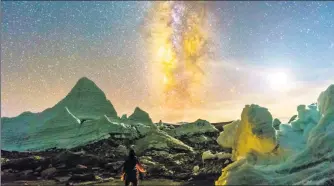  ?? CHEN JILI / FOR CHINA DAILY ?? Kelsang, a Tibetan man who guided amateur astronomer Chen Jili, observes the night sky from a glacier in the Tibet autonomous region this month.