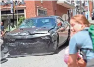  ?? ASSOCIATED PRESS ?? A man reverses a vehicle after driving into a group of protesters demonstrat­ing against a white nationalis­t rally in Charlottes­ville, Va., on Saturday.